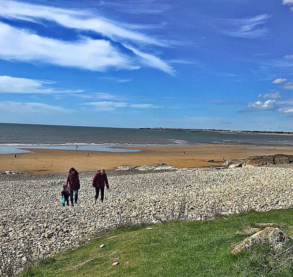 Walking with the family on the beach in southern Wales, UK