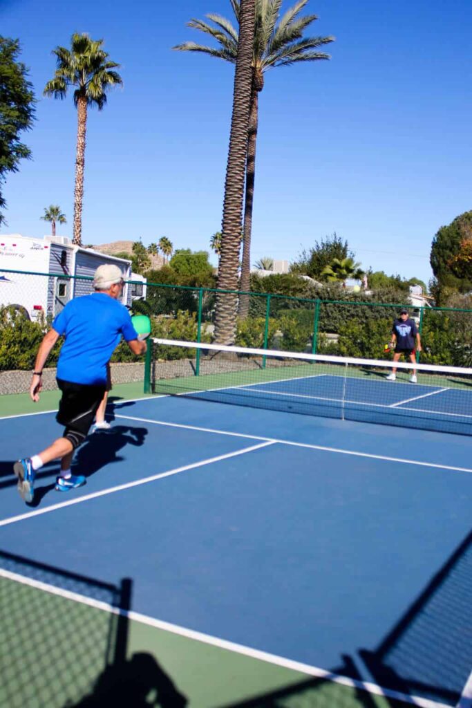 Multigenerational family travel at a Hemet RV resort playing pickleball