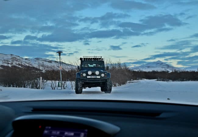 jeep ina standoff with a car in the snow in iceland