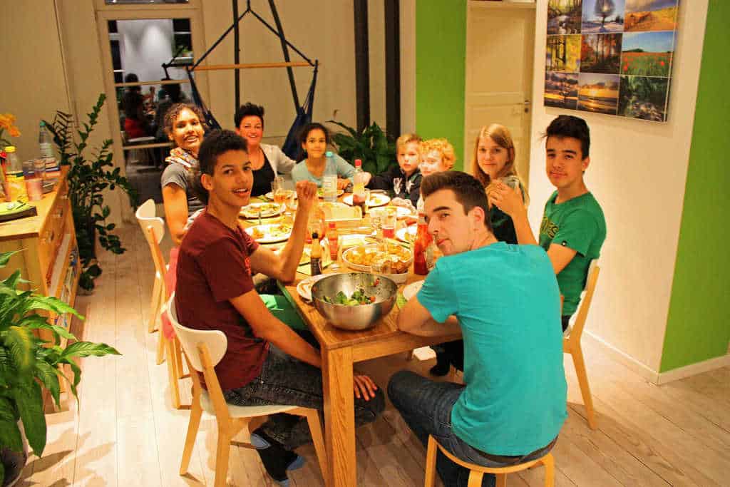 big group family at a dining room table smiling at camera