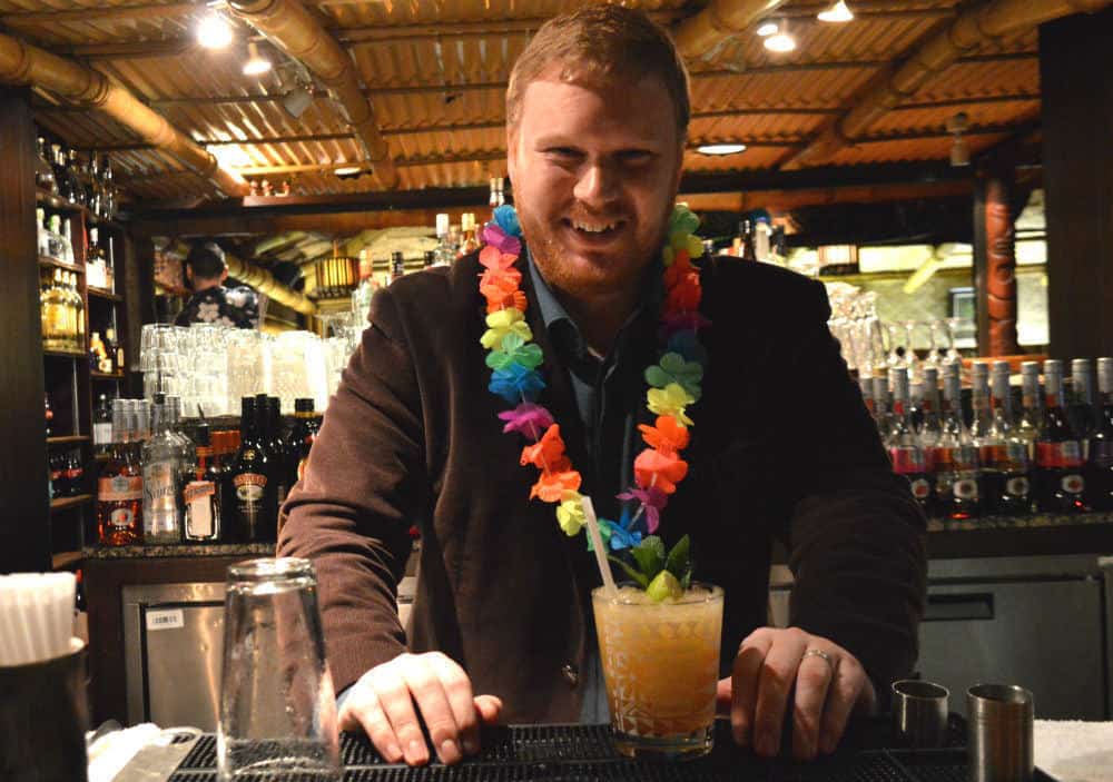 christian with his mai tai and lei at trader vic's london