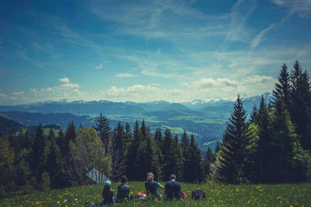 group outdoors in nature blue hued with mountains