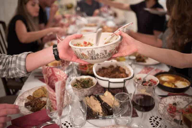 Group meal in israel with table full of dishes