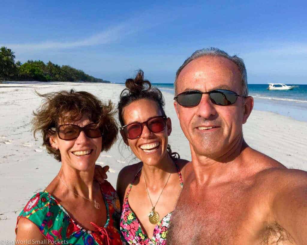 Stephanie with group travel family on beach in Kenya