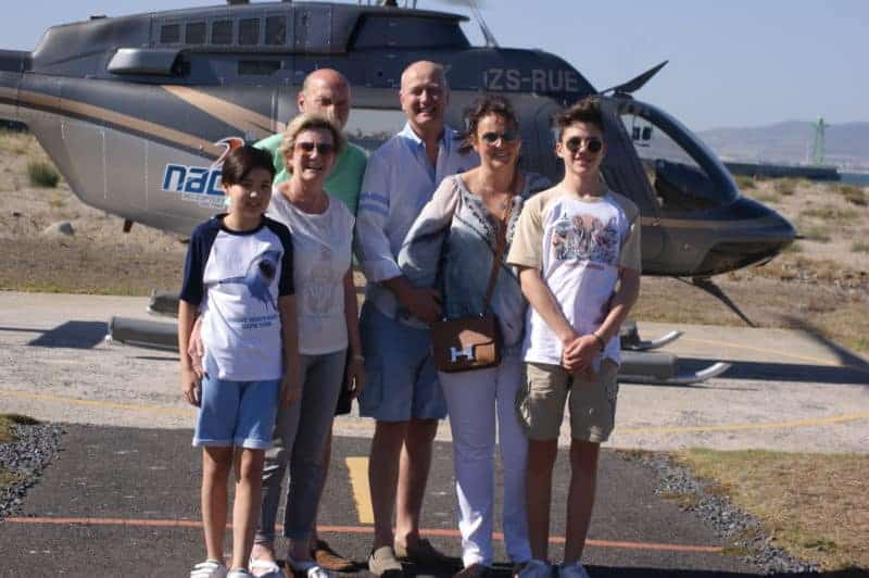 family in front of helicopter in south africa