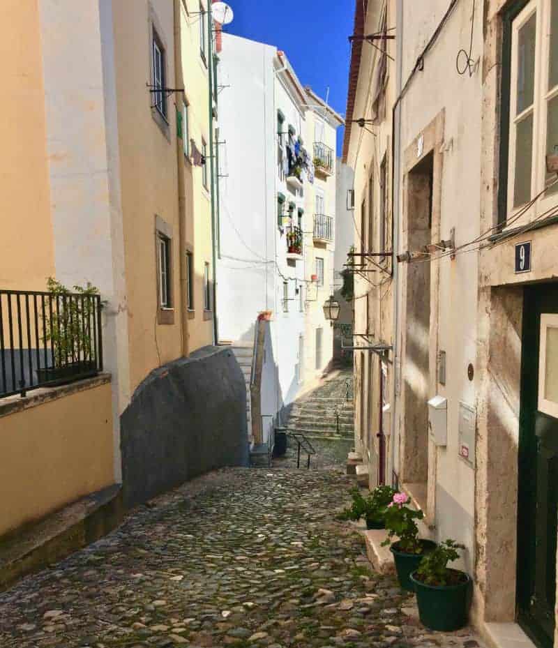 sunny alley in lisbon portugal