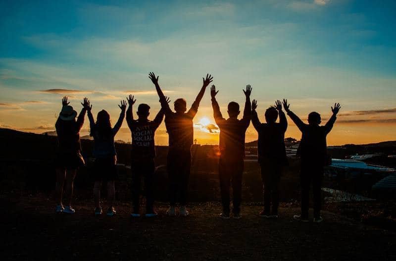 group of people silhouette by sunset