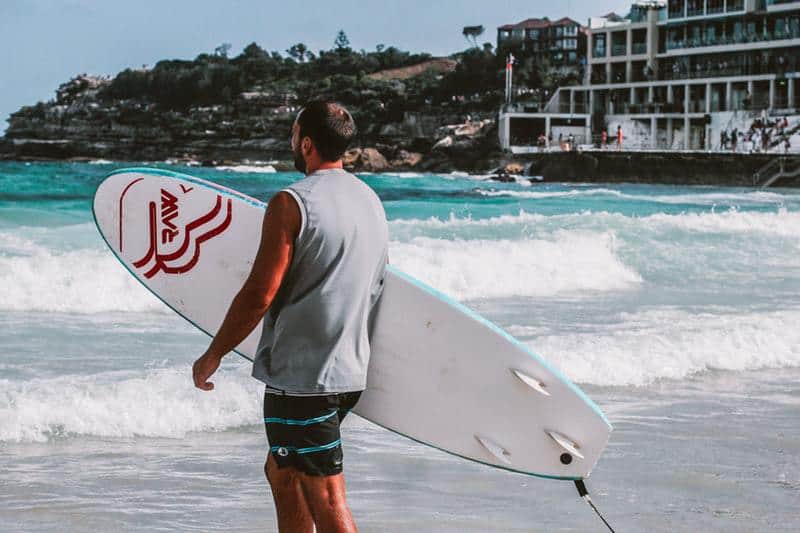 guy with surfboard at bondi beach