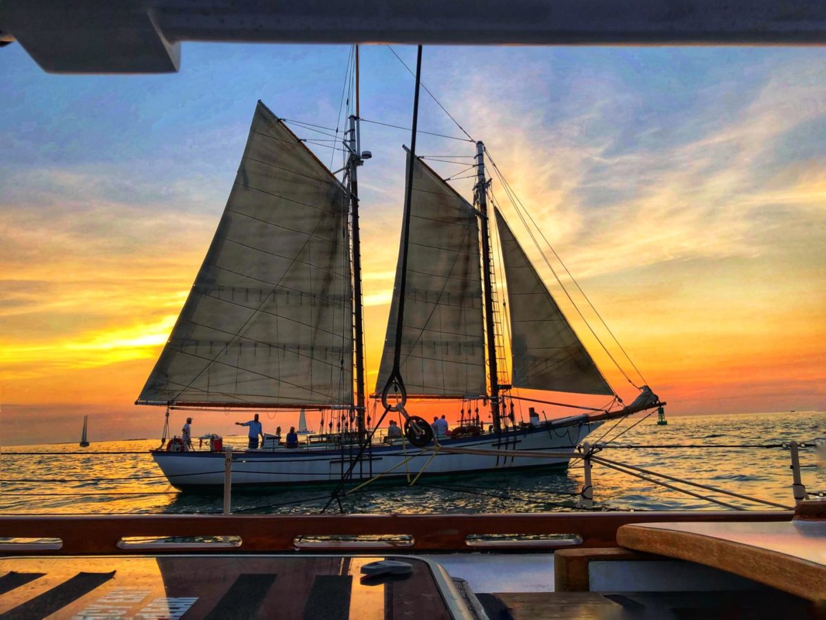 Sailboat siluette at sunset in key west florida with classic harbor line