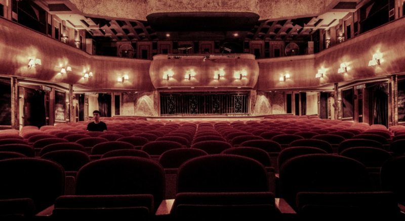 west end theater with curtain stage and chairs london