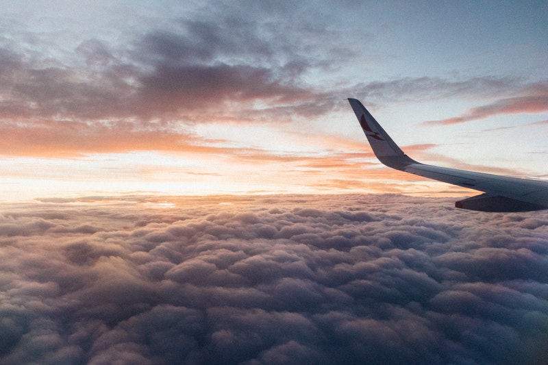 plane wing over clouds